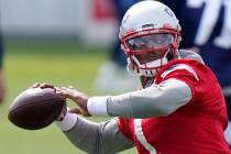 In this Wednesday, Aug. 26, 2020, file photo, New England Patriots quarterback Cam Newton (1) w ...
