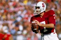 In this Oct. 1982, file photo, Stanford University quarterback John Elway looks to pass during ...