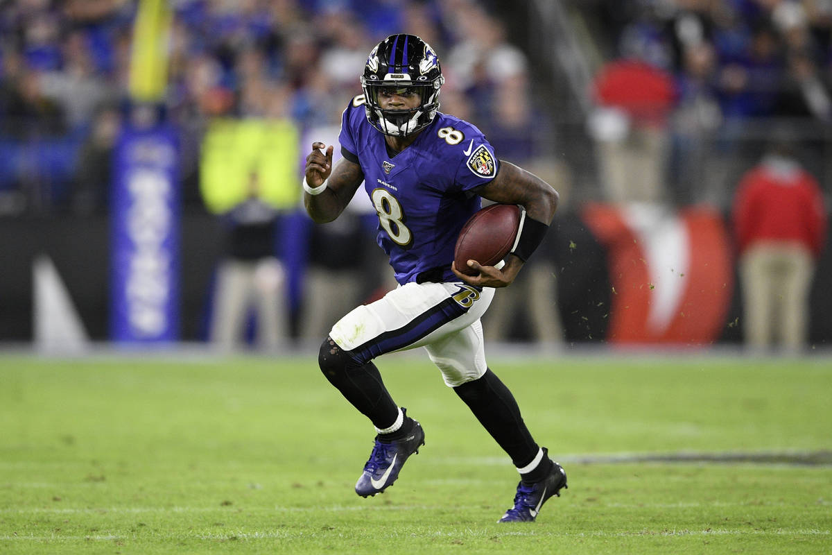 FILE - Baltimore Ravens quarterback Lamar Jackson (8) scrambles during the second half of an NF ...