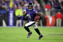 FILE - Baltimore Ravens quarterback Lamar Jackson (8) scrambles during the second half of an NF ...