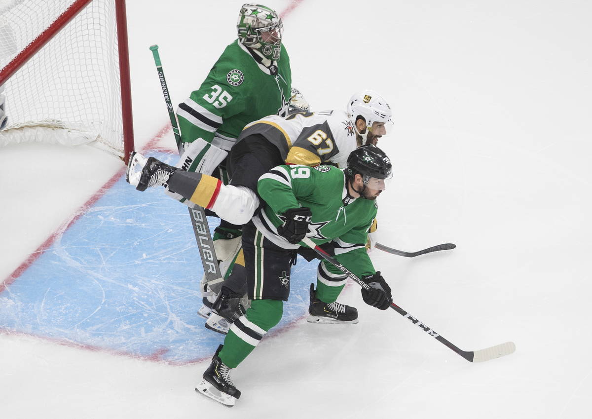 Dallas Stars' Joel Hanley (39) and Vegas Golden Knights' Max Pacioretty (67) battle in front of ...
