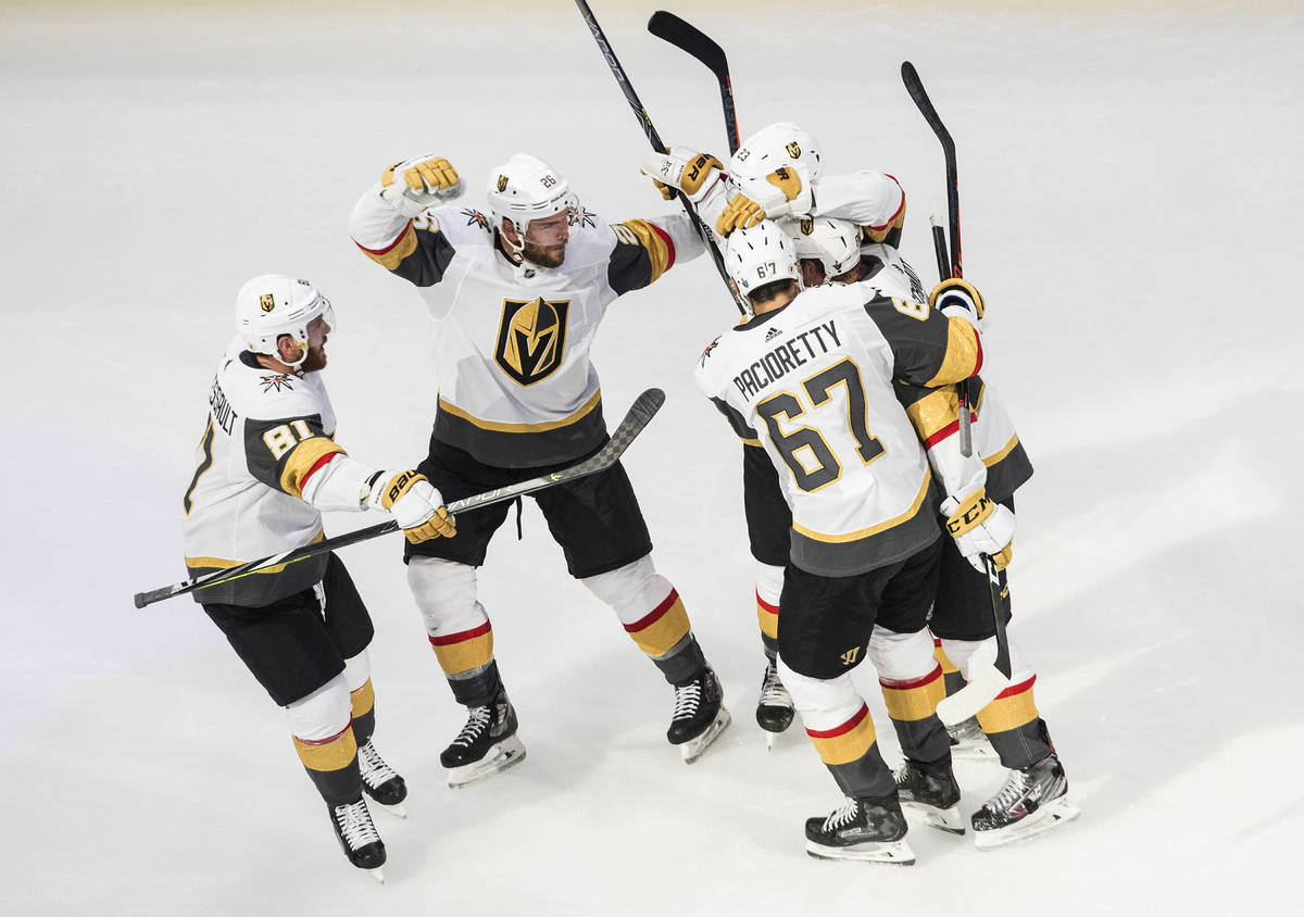 Vegas Golden Knights' Alec Martinez (23) celebrates his goal against the Dallas Stars with team ...