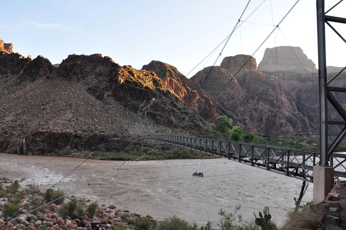 Boaters on the Colorado River pass under the Silver Bridge while getting an early start on thei ...