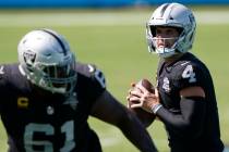 Las Vegas Raiders quarterback Derek Carr looks to pass during the second half of an NFL footbal ...