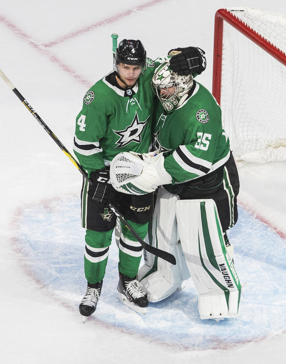 Dallas Stars' Miro Heiskanen (4) and goalie Anton Khudobin (35) celebrate the team's win over t ...