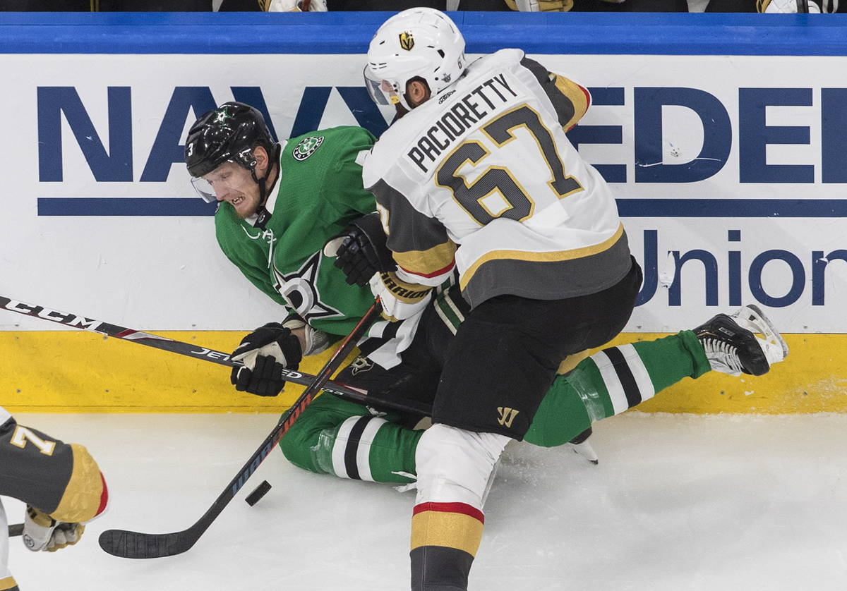 Dallas Stars' John Klingberg (3) is checked by Vegas Golden Knights' Max Pacioretty (67) during ...