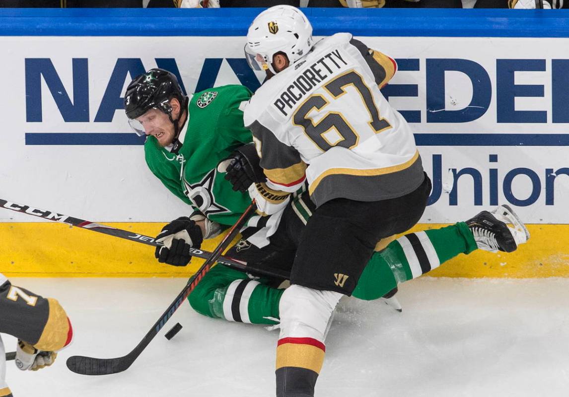 Dallas Stars' John Klingberg (3) is checked by Vegas Golden Knights' Max Pacioretty (67) during ...