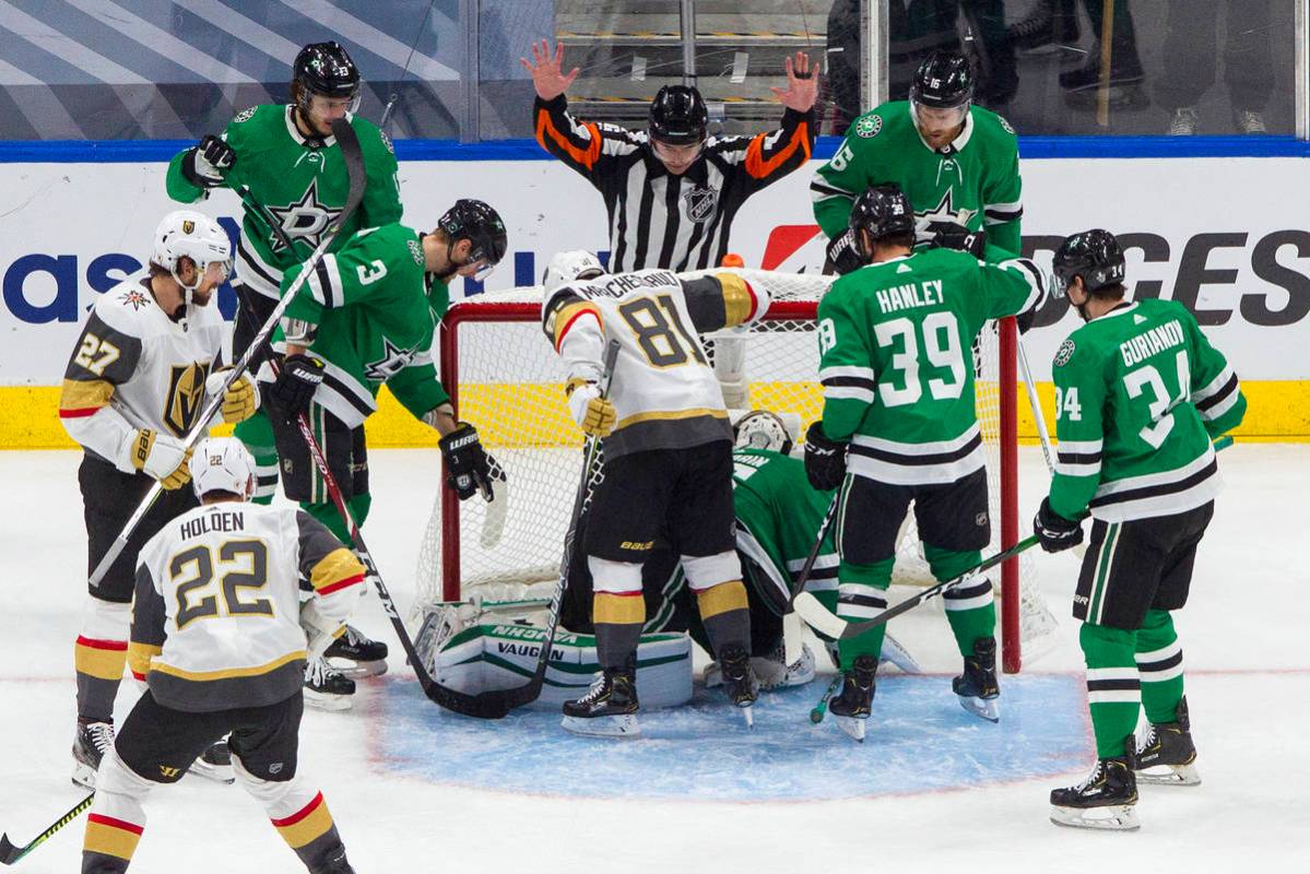The referee calls a no goal as Dallas Stars and Vegas Golden Knights players look toward the ne ...