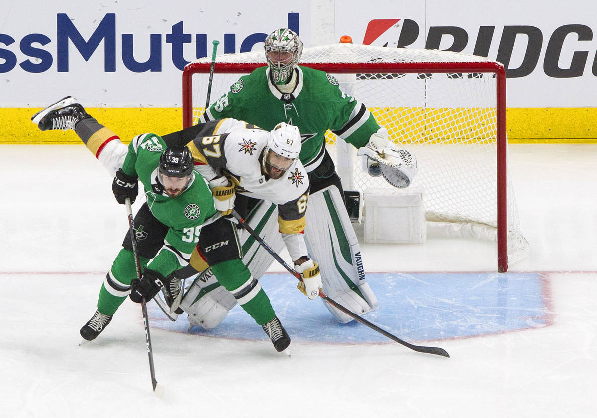 Dallas Stars' Joel Hanley (39) and Vegas Golden Knights' Max Pacioretty (67) battle in front of ...