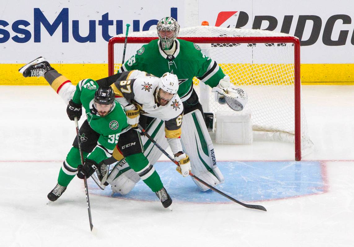 Dallas Stars' Joel Hanley (39) and Vegas Golden Knights' Max Pacioretty (67) battle in front of ...