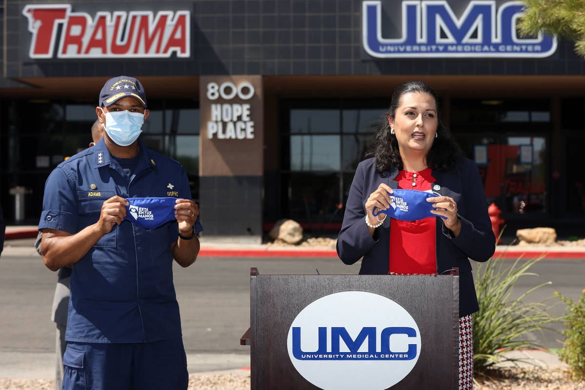 Vice Admiral Jerome M. Adams, U.S. Surgeon General speaks, left, with Las Vegas Councilwoman Ol ...