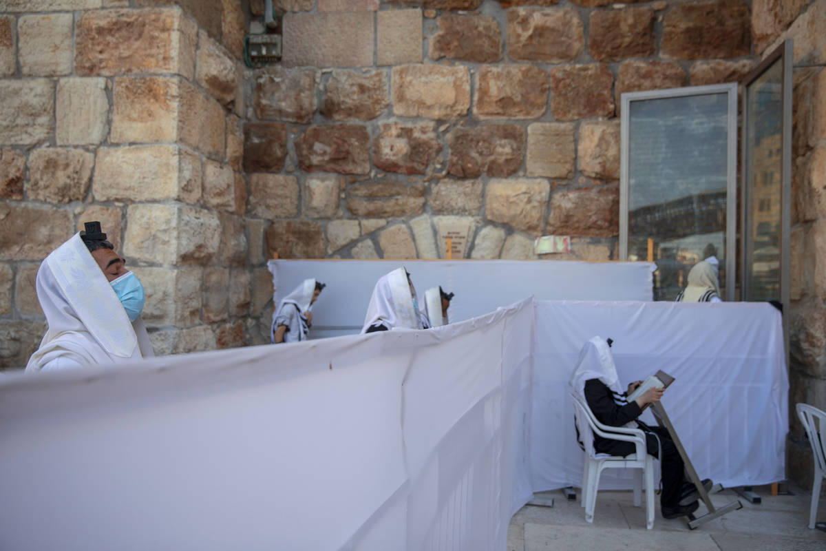 FILE - In this July 16, 2020 file photo, ultra-Orthodox Jewish men pray in divided sections whi ...