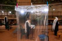 FILE - In this Tuesday, Sept 8, 2020 file photo, ultra-Orthodox Jews keep social distancing and ...