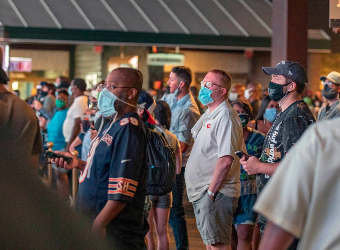 Individuals watch games at the Westgate Sportsbook during opening weekend, in Las Vegas on Sund ...