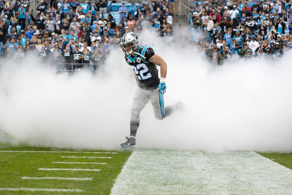 Carolina Panthers running back Christian McCaffrey (22) running onto the field during an NFL ga ...