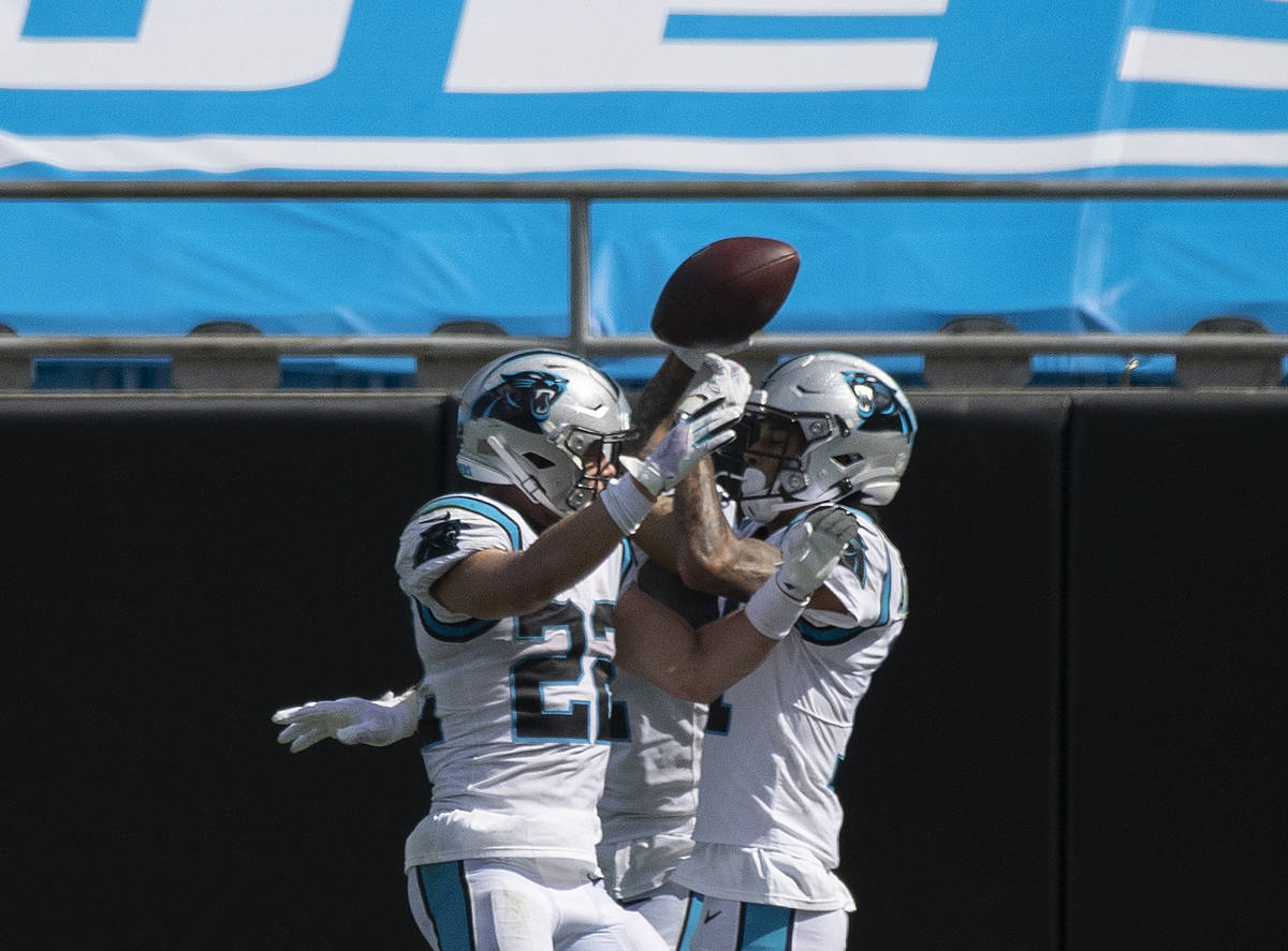 Carolina Panthers running back Christian McCaffrey (22) celebrates a Panthers touchdown with te ...