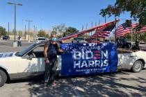 Eddie Ramos poses in front of his old limousine, which he covered in posters and American flags ...