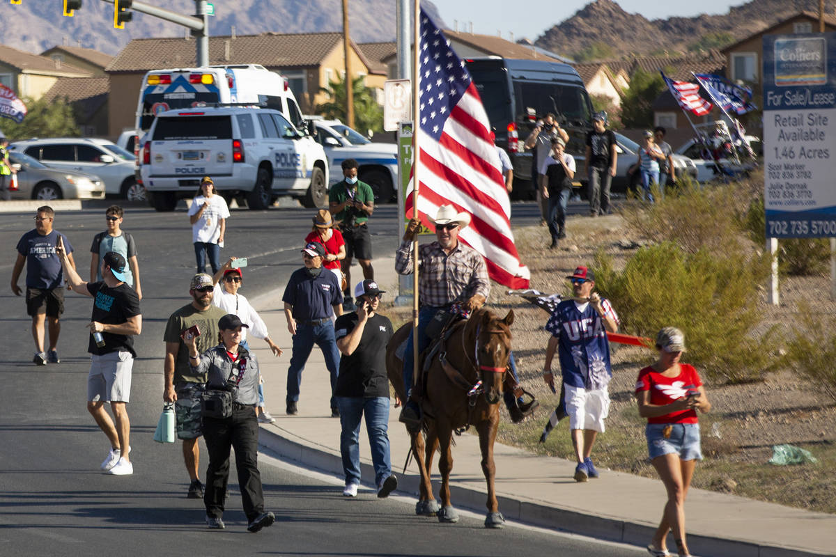 One man rides in on horseback to wait in line for President Donald Trump's campaign rally at Xt ...