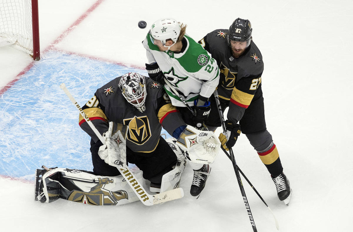 Dallas Stars' Roope Hintz (24) and Vegas Golden Knights' Shea Theodore (27) battle as Golden Kn ...