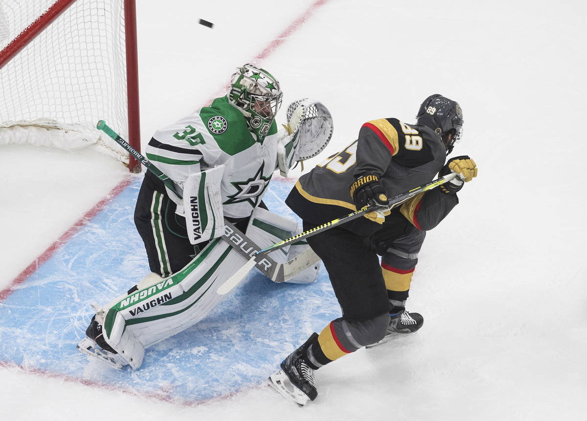 Dallas Stars' goalie Anton Khudobin (35) makes a save as Vegas Golden Knights' Alex Tuch (89) s ...