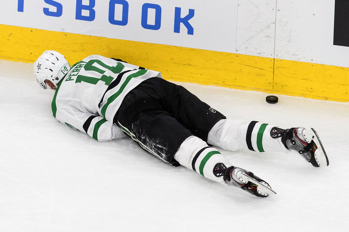 Dallas Stars' Corey Perry (10) lies injured on the ice during second-period NHL Western Confere ...