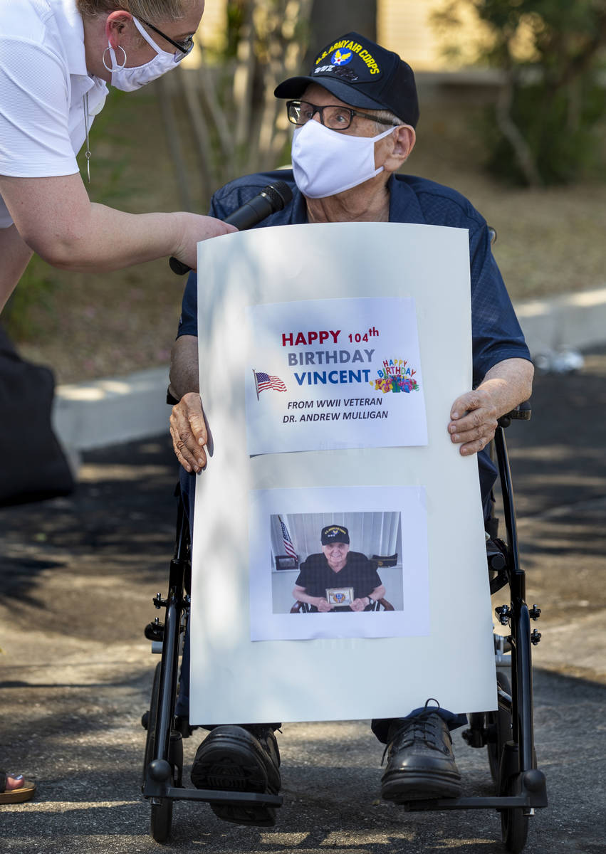 Dr. Andrew Mulligan, a World War II veteran, offers some kind words of friend Vincent Shank, a ...