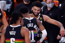 Denver Nuggets' Jamal Murray, right, celebrates with Monte Morris (11) after an NBA conference ...