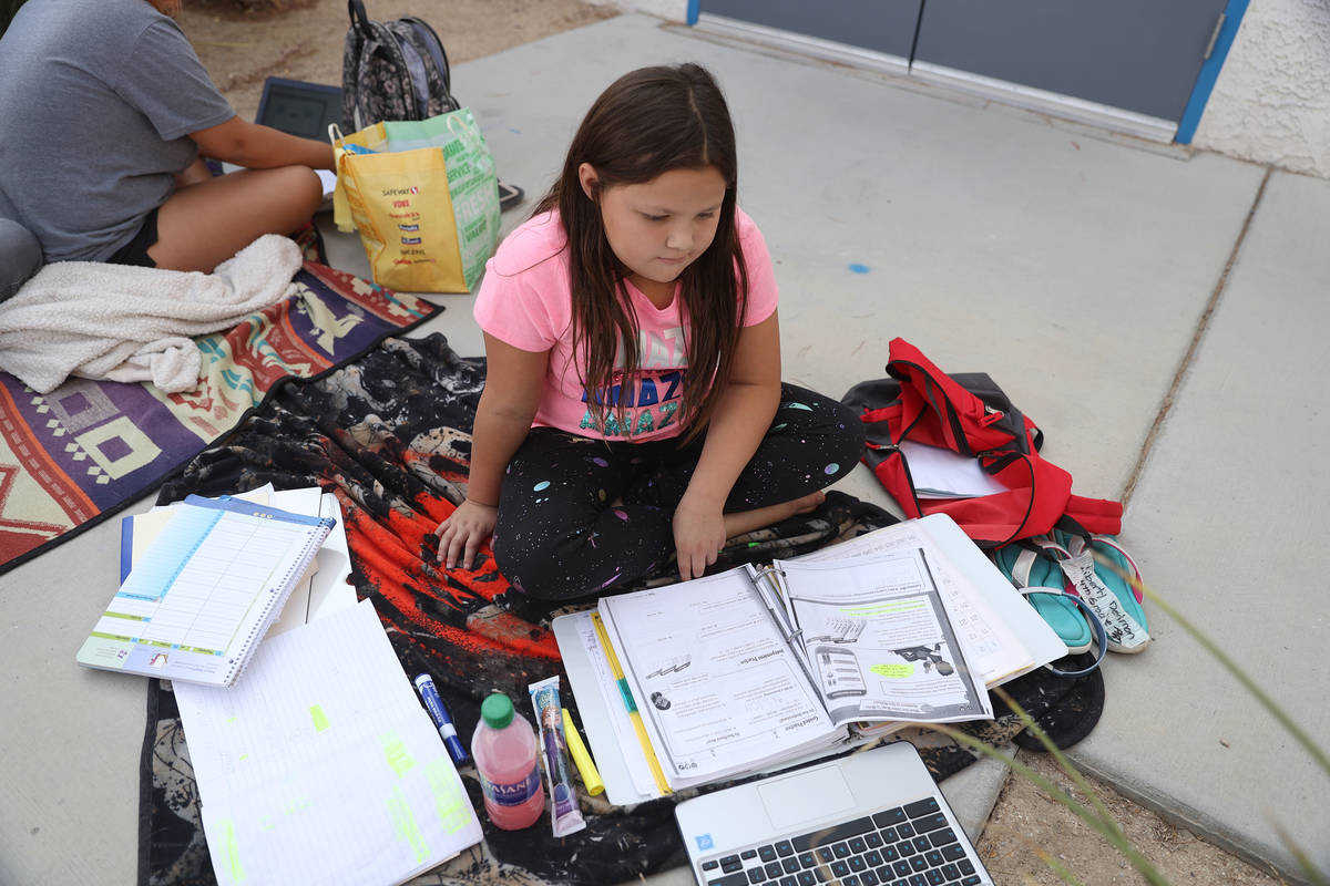 Liberty Dedmon, 9, participates in her virtual class using the school Wi-Fi outside of Indian S ...