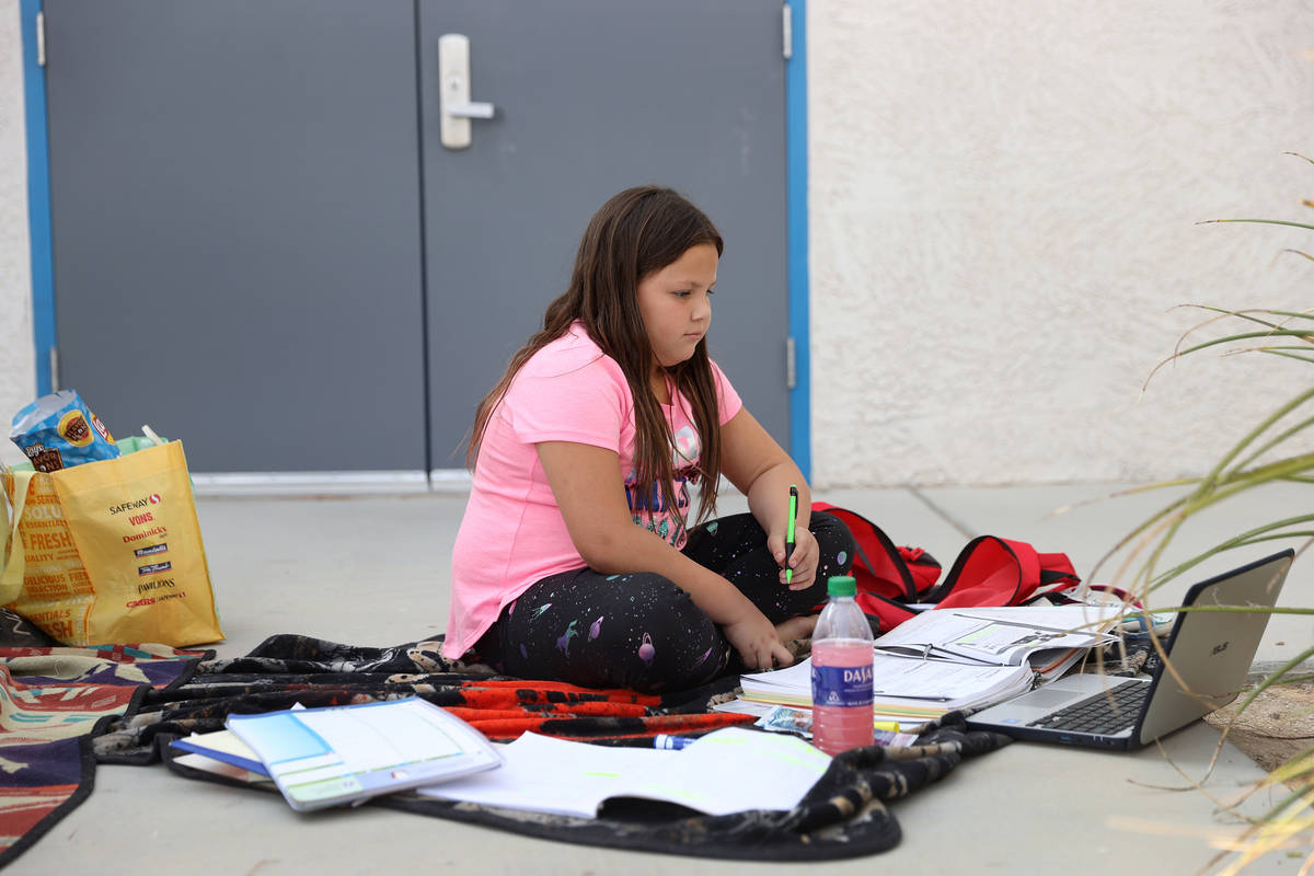 Liberty Dedmon, 9, participates in her virtual class using the school Wi-Fi outside of Indian S ...