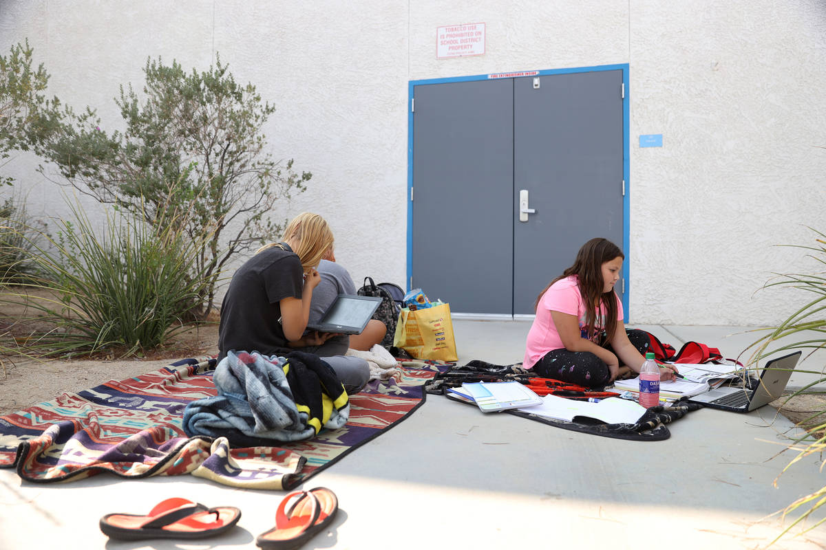 Siblings, clockwise from left, Shayne, 13, Imogen, 15, and Liberty Dedmon, 9, participate in th ...