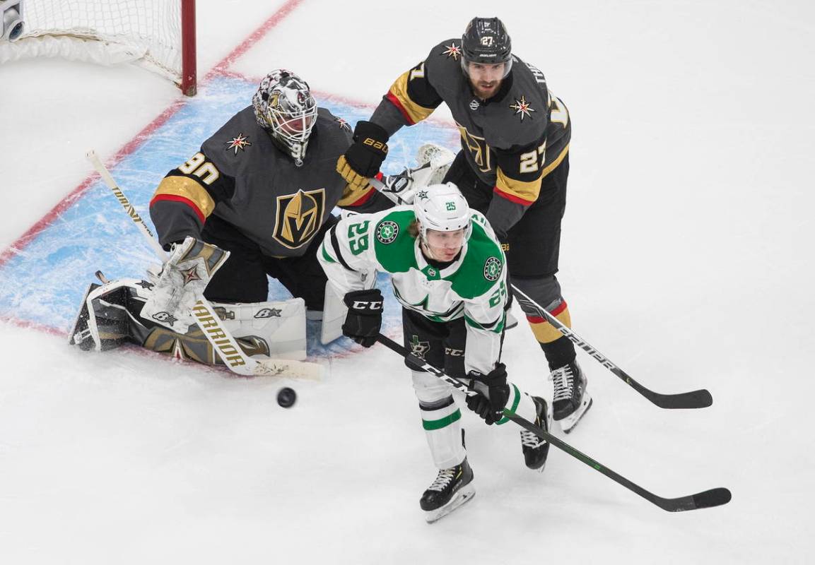 Dallas Stars' Joel Kiviranta (25) and Vegas Golden Knights' Shea Theodore (27) look for a rebou ...