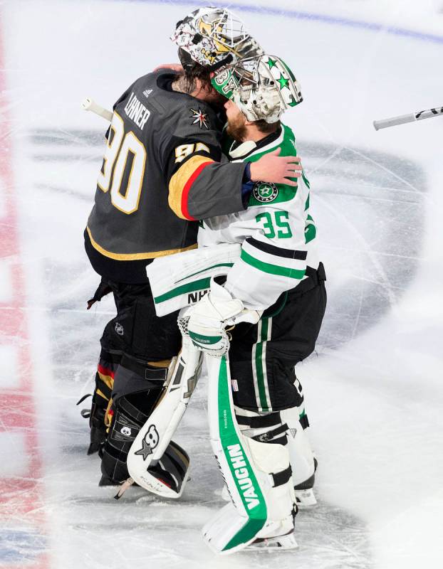 Dallas Stars goalie Anton Khudobin (35) and Vegas Golden Knights goalie Robin Lehner (90) hug a ...