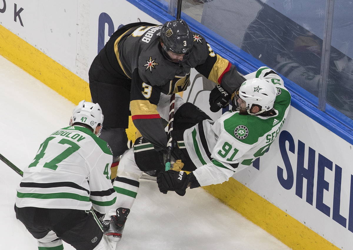Dallas Stars' Tyler Seguin (91) is checked by Vegas Golden Knights' Brayden McNabb (3) during s ...