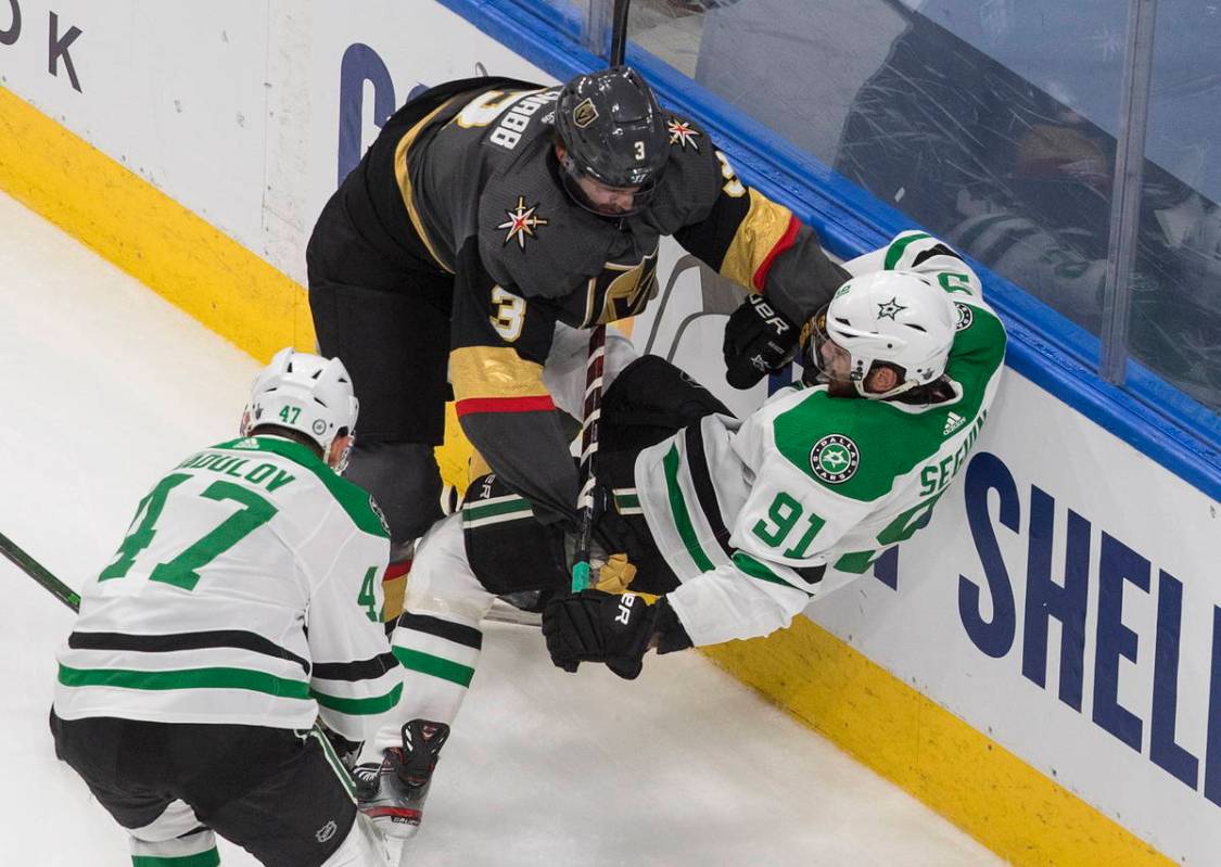Dallas Stars' Tyler Seguin (91) is checked by Vegas Golden Knights' Brayden McNabb (3) during s ...