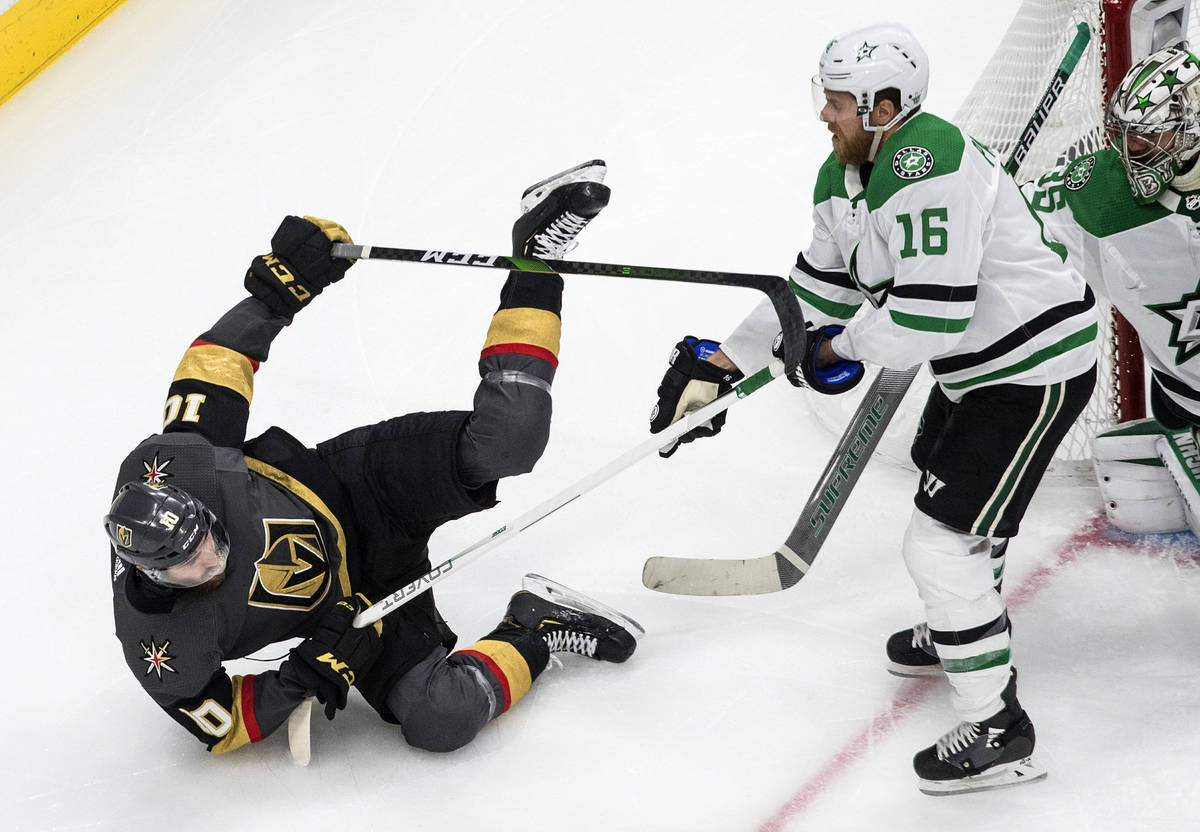 Dallas Stars' Joe Pavelski (16) checks Vegas Golden Knights' Nicolas Roy (10) during second-per ...