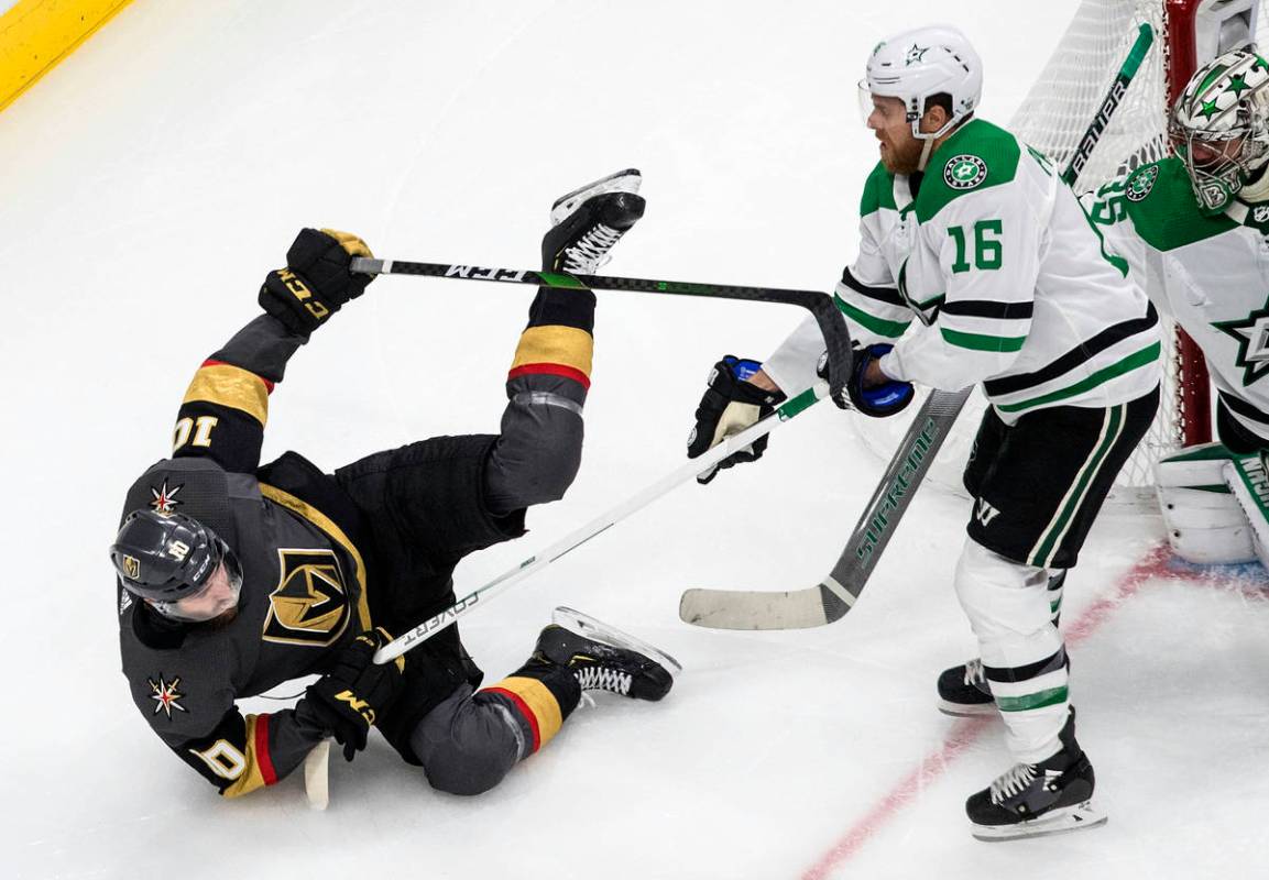 Dallas Stars' Joe Pavelski (16) checks Vegas Golden Knights' Nicolas Roy (10) during second-per ...