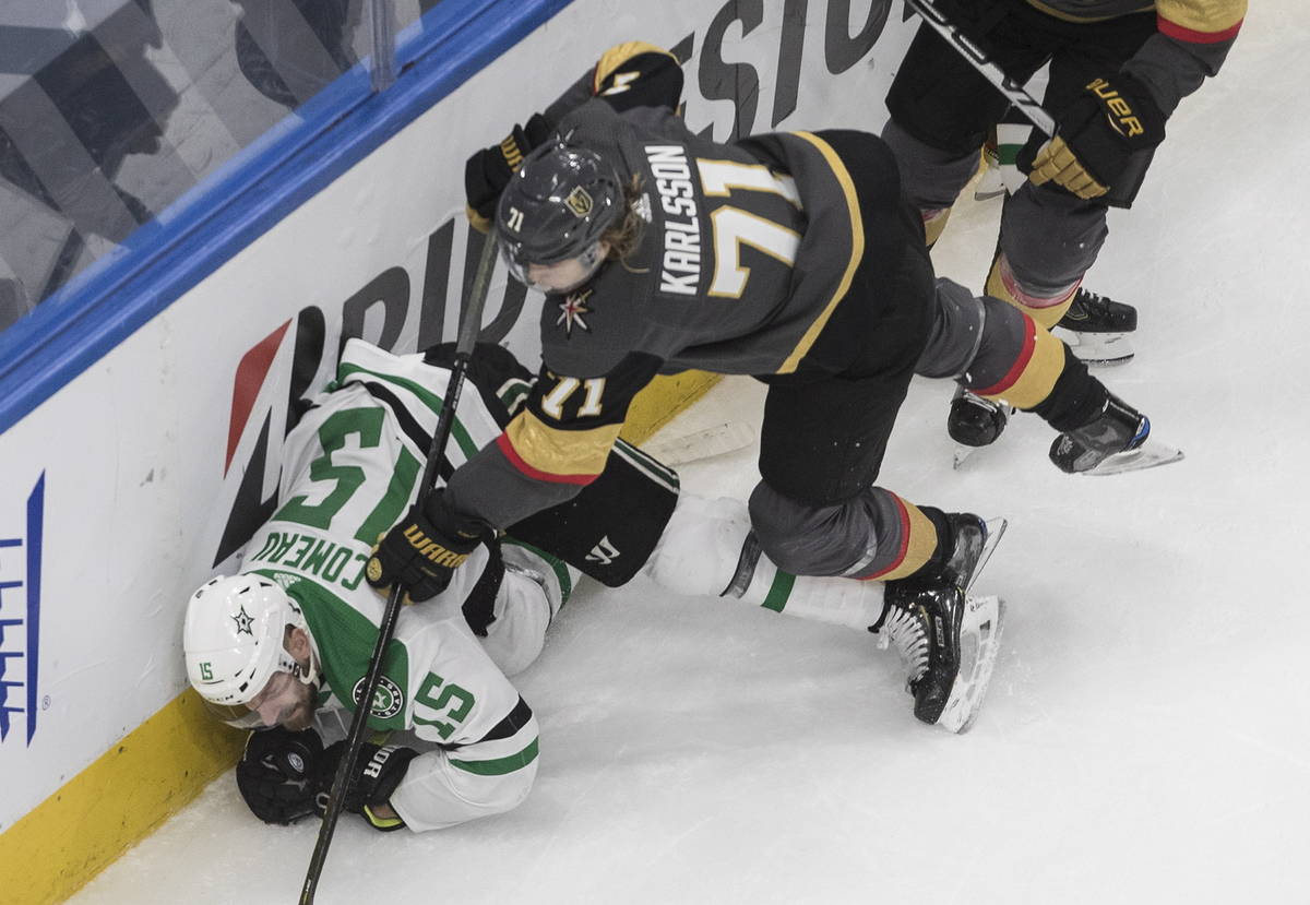 Dallas Stars' Blake Comeau (15) is checked by Vegas Golden Knights' William Karlsson (71) durin ...