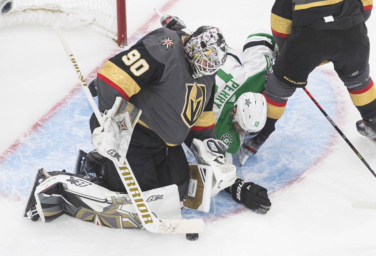Dallas Stars' Corey Perry (10) reaches for the puck as Vegas Golden Knights goalie Robin Lehner ...