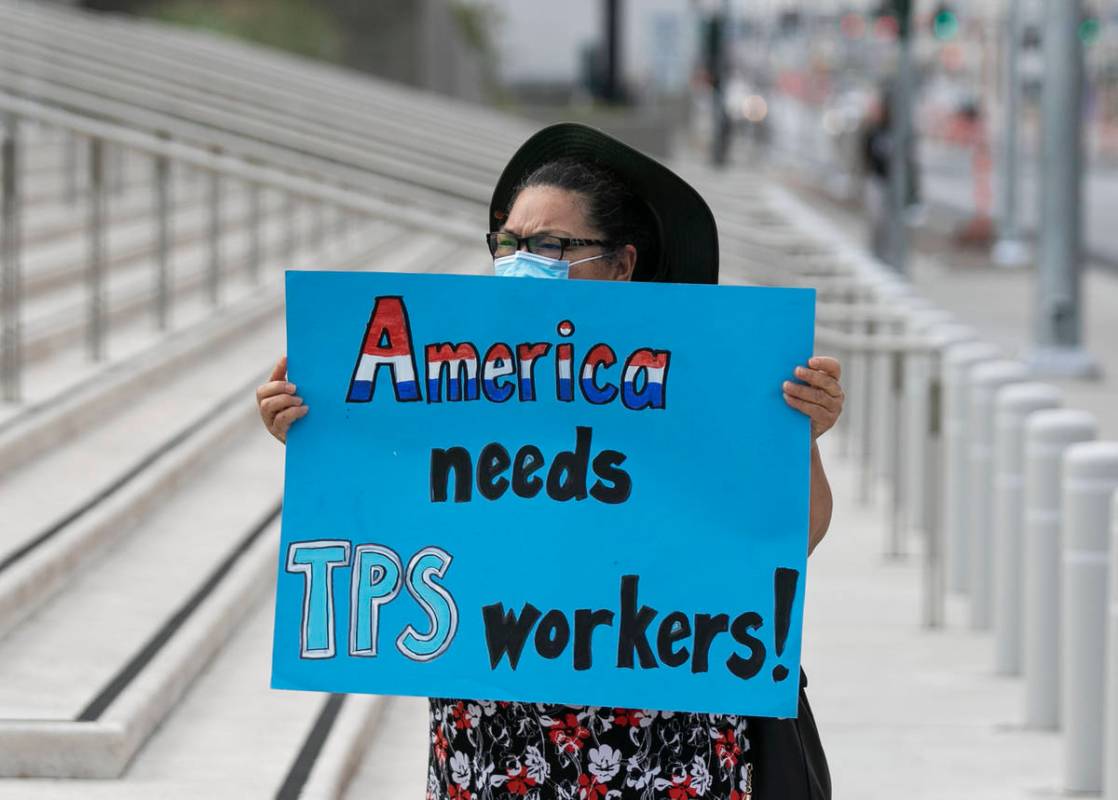 Mirna Rodriguez holds a sign as Temporary Protective Status (TPS) holders and community partner ...