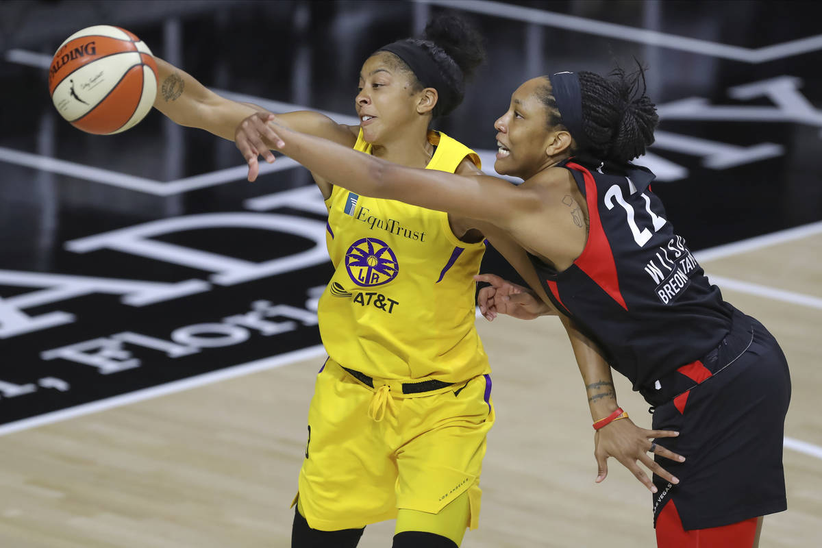 Las Vegas Aces' A'ja Wilson (22) reaches to deflect a pass intended for Los Angeles Sparks' Can ...