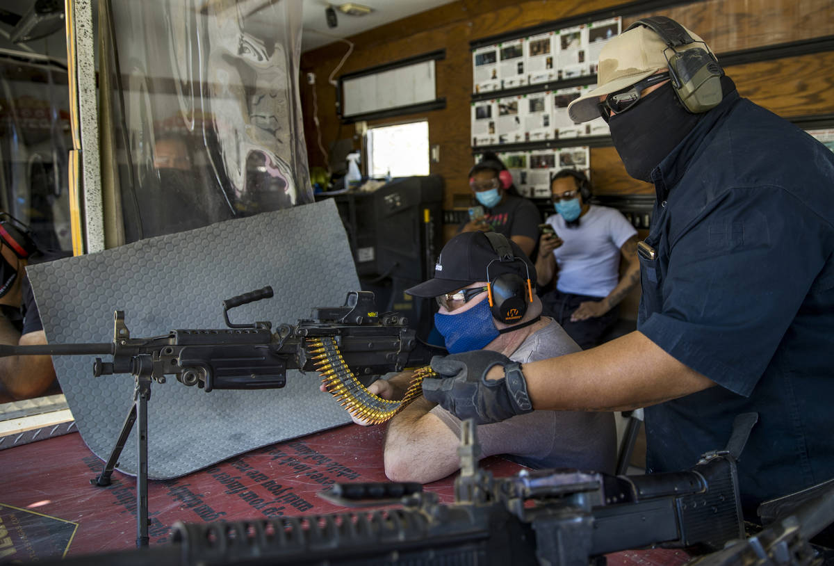 Christopher Lawrence, center, fires an M249 Saw machine gun assisted by Sam Davidson on the Adr ...