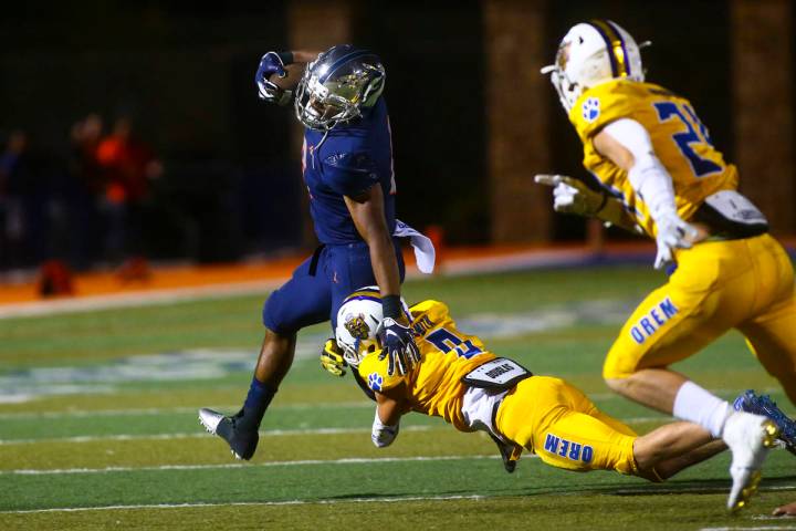 Bishop Gorman's Ikaika Ragsdale is stopped by Orem's Joe Smith (9) during the second half of a ...