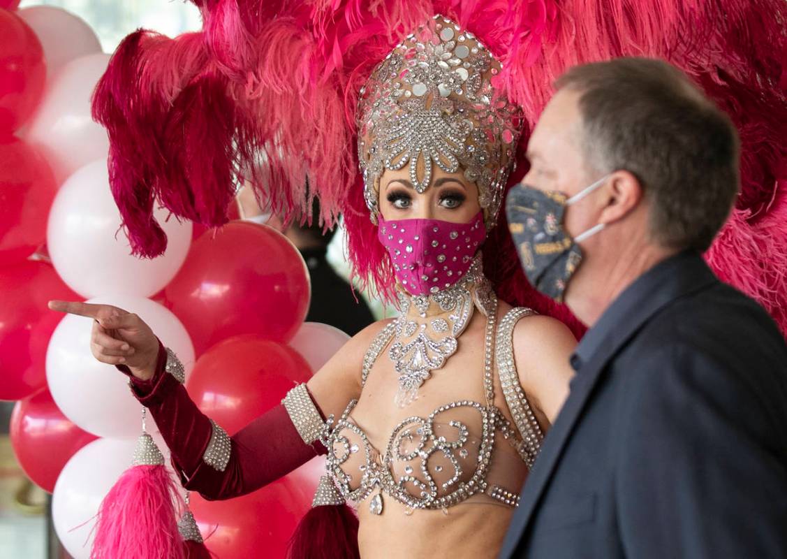 Show girl Kaleigh Jones, left, and Andy Swenson, vice president of marketing, chat as they prep ...