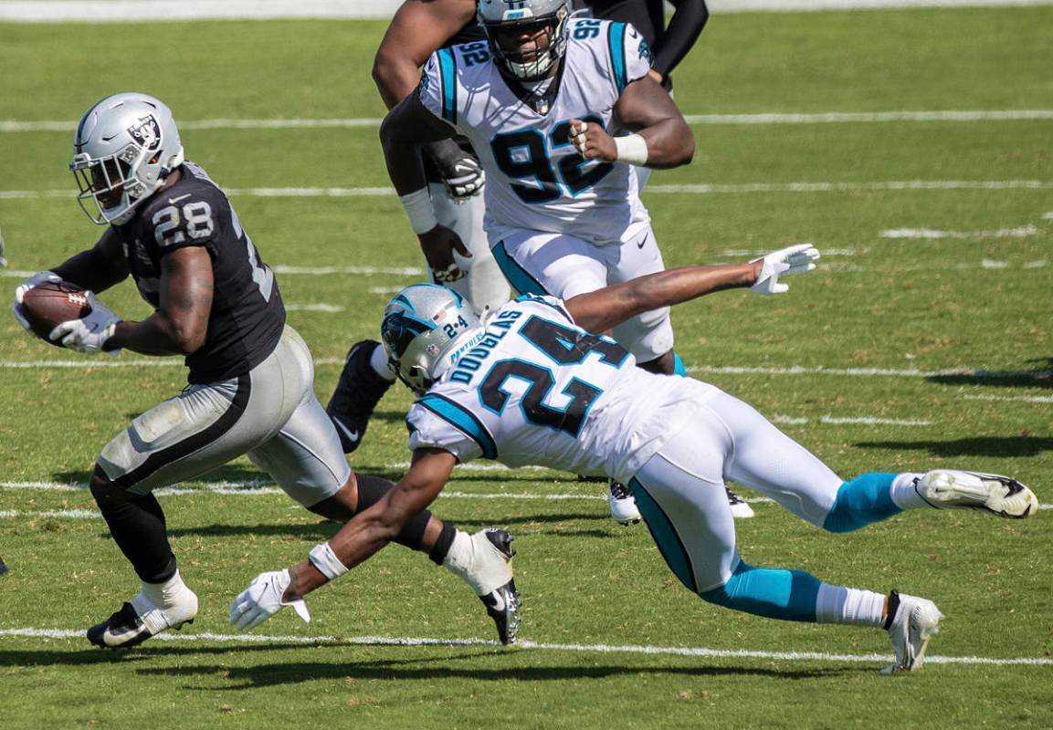 Las Vegas Raiders running back Josh Jacobs (28) runs up field past Carolina Panthers cornerback ...
