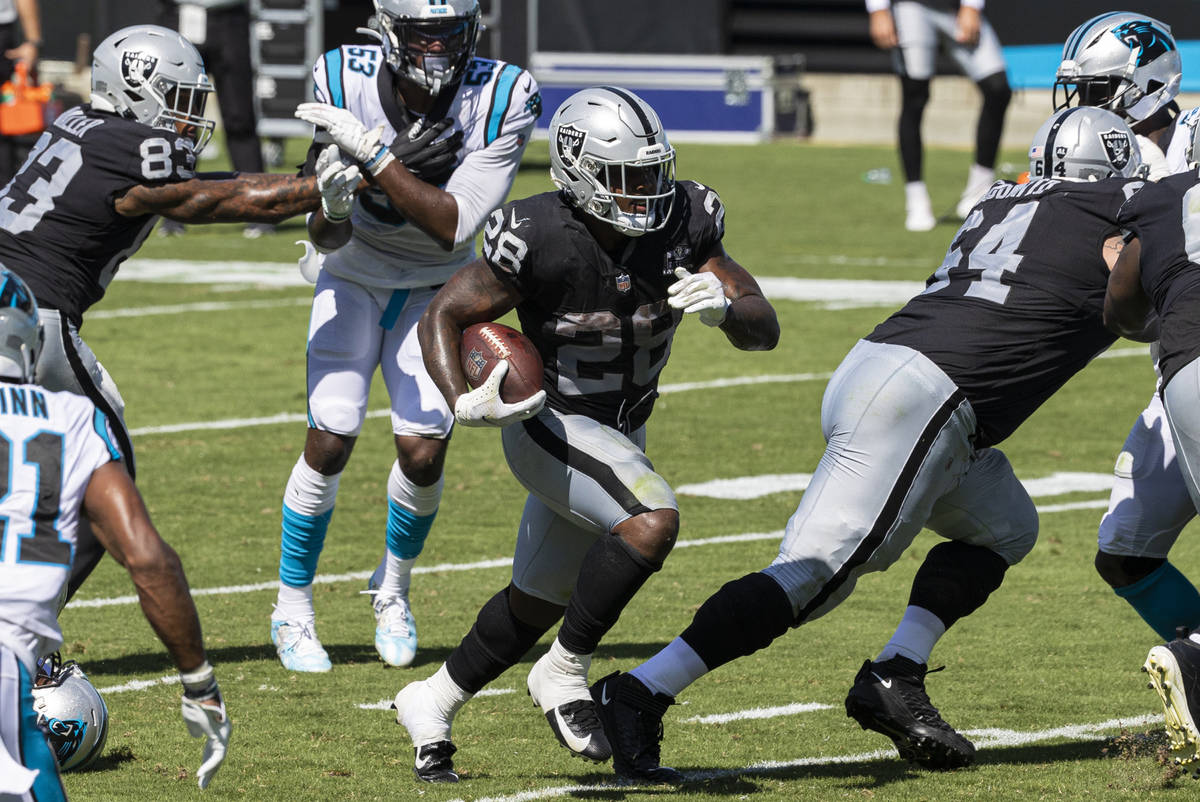 Las Vegas Raiders running back Josh Jacobs (28) rushes for a third-quarter touchdown past Carol ...