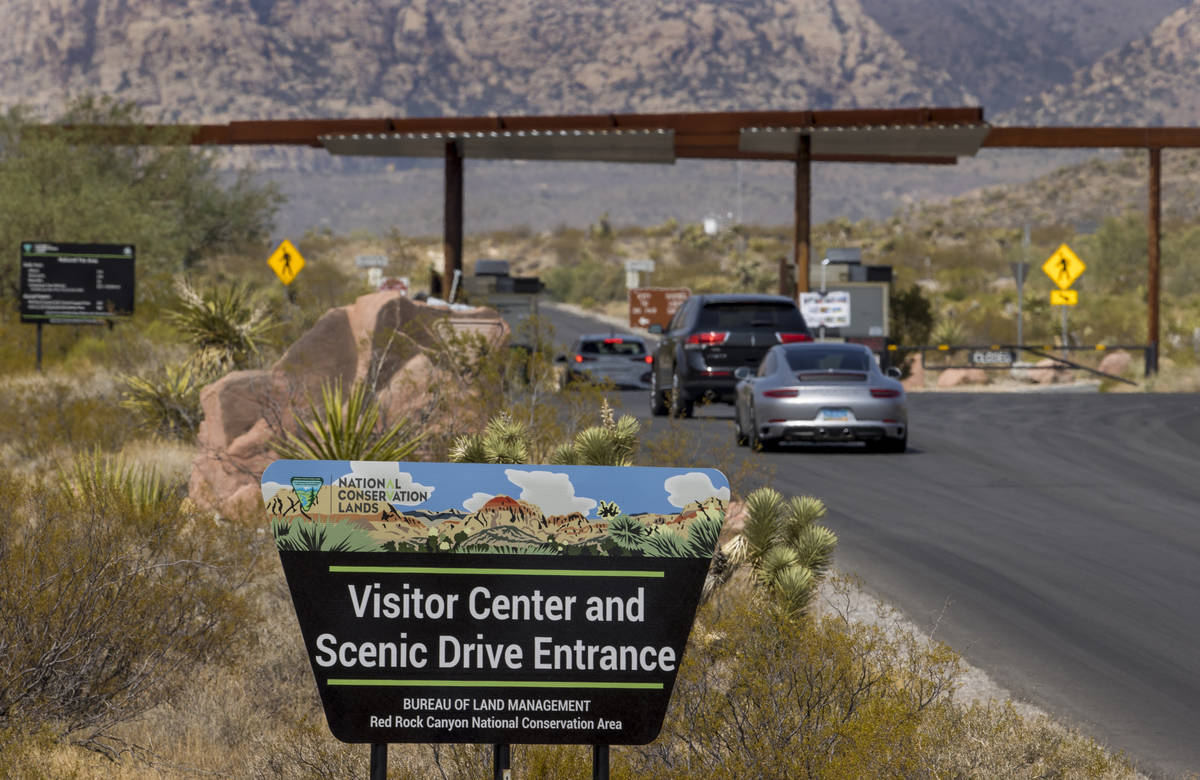An entrance marker and vehicles for the Red Rock Canyon National Recreation Area which is start ...