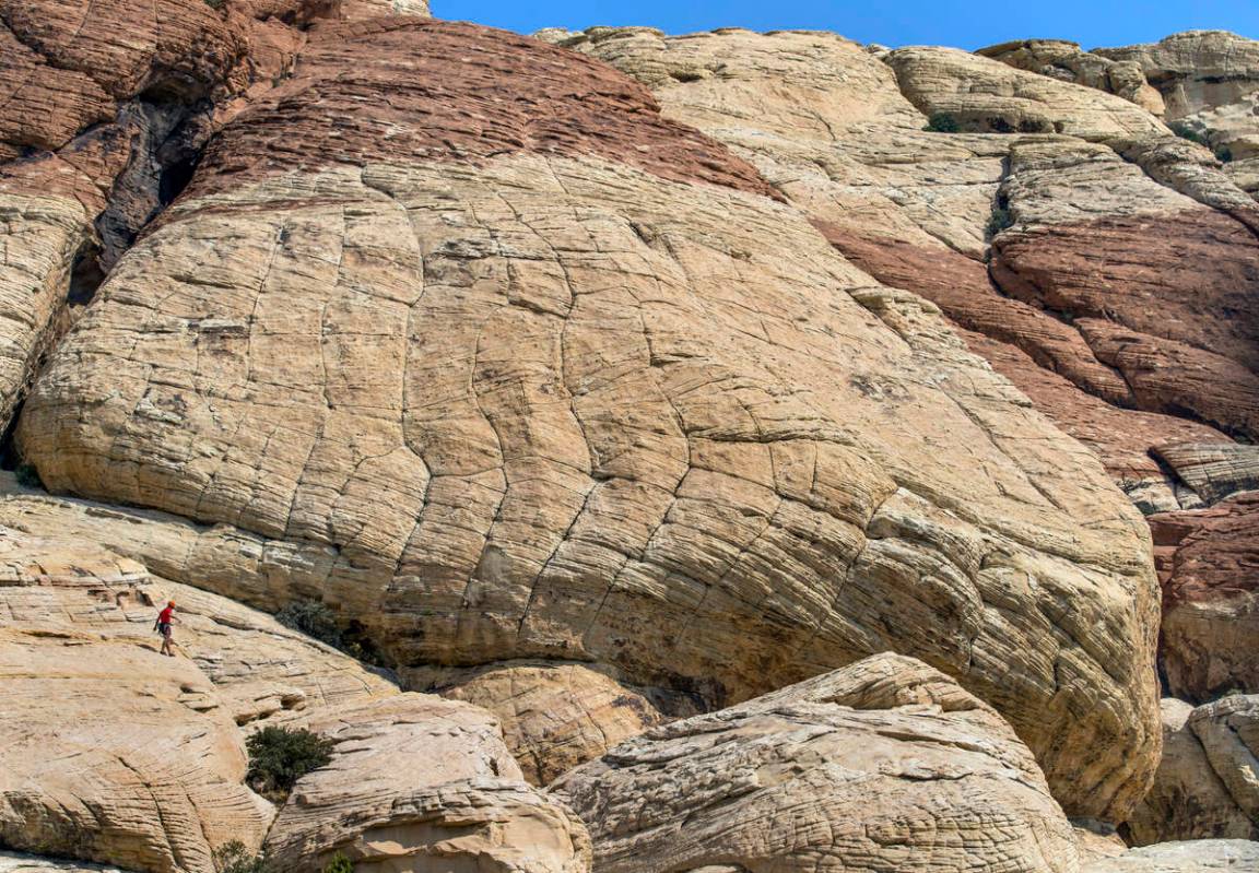 A climber makes his way down from the Sandstone Quarry in the Red Rock Canyon National Recreati ...