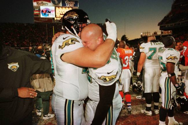 Jacksonville Jaguars' Brian DeMarco, left, and Michael Cheever hug after their 30-27 win over t ...