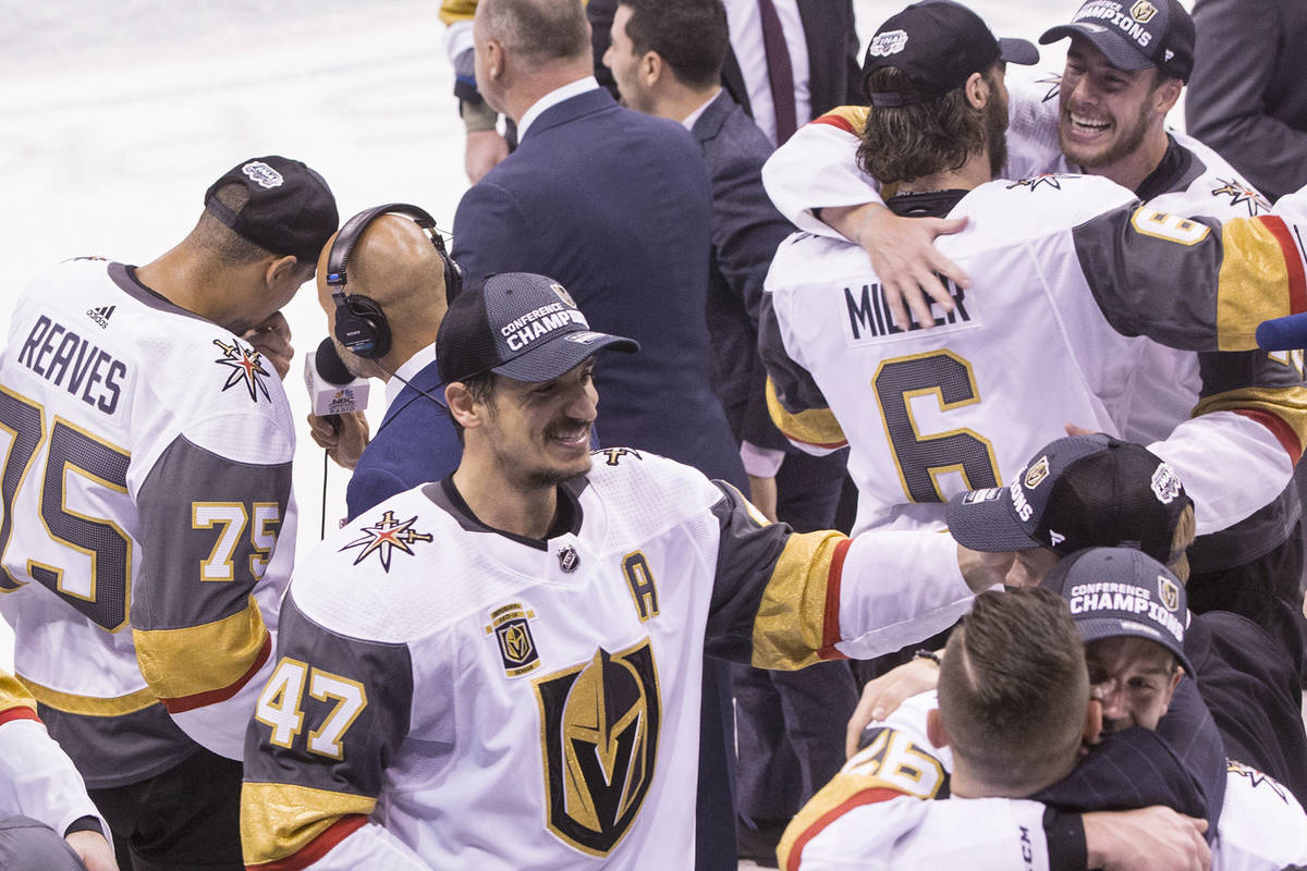 Golden Knights players and staff celebrate after beating the Winnipeg Jets 2-1 to advance to th ...