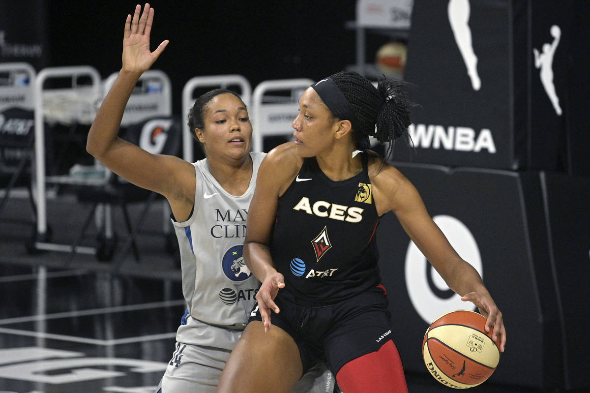 Las Vegas Aces center A'ja Wilson backs into position in front of Minnesota Lynx forward Naphee ...